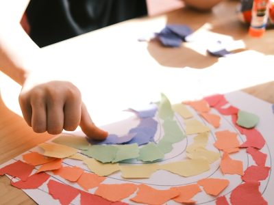 person holding pink and white heart print paper